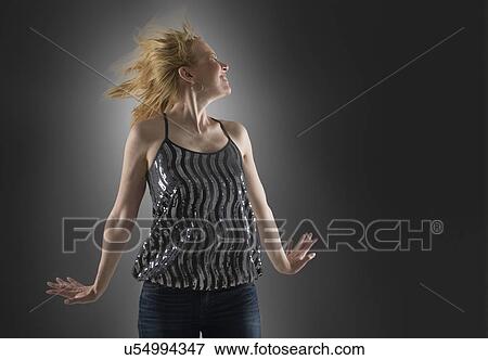 Happy woman dancing in studio View Large Photo Image Stock Photo - Happy woman dancing in studio. Fotosearch