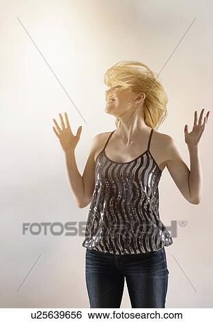 Stock Photograph - Happy woman dancing in studio. Fotosearch
