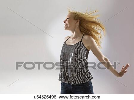 Happy woman dancing in studio View Large Photo Image Stock Photograph - Happy woman dancing in studio. Fotosearch