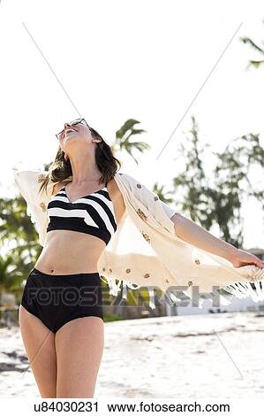 Stock Image - Happy woman on beach . Fotosearch