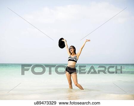 Stock Photo - Happy woman on beach. Fotosearch