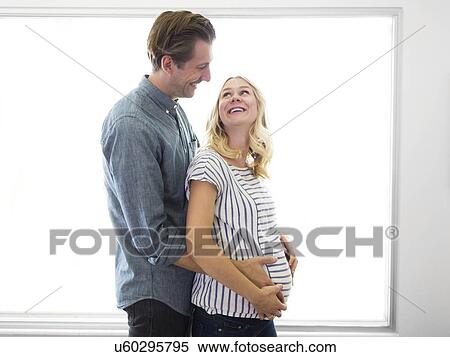 Husband embracing pregnant wife View Large Photo Image Stock Photography - Husband embracing pregnant wife. Fotosearch
