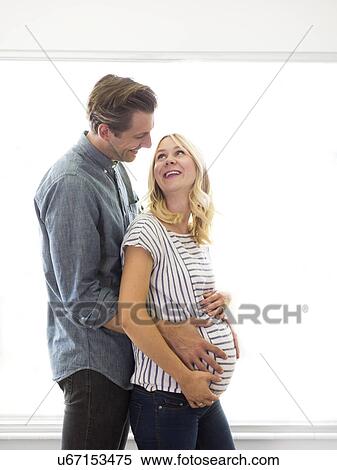 Husband embracing pregnant wife View Large Photo Image Stock Photography - Husband embracing pregnant wife. Fotosearch