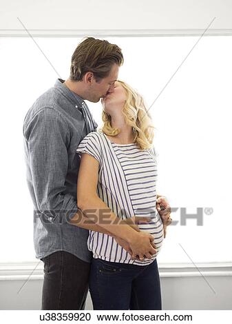 Husband kissing pregnant wife View Large Photo Image Stock Image - Husband kissing pregnant wife. Fotosearch