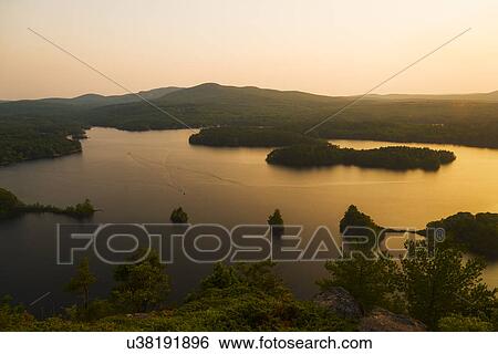 Stock Photograph - Landscape with lake at sunset. Fotosearch