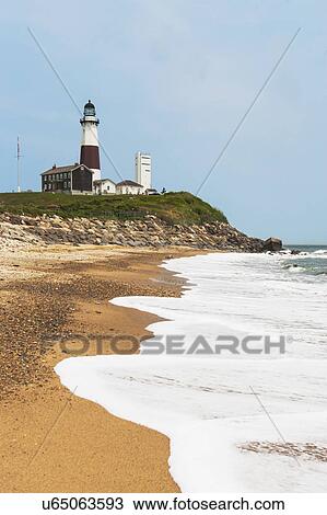 Stock Image - Lighthouse on cliff over sea. Fotosearch