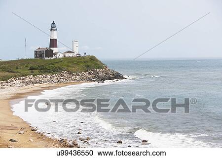 Stock Image - Lighthouse on cliff over sea. Fotosearch