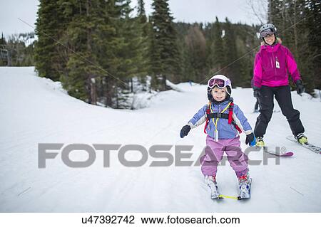 Little girl (2-3) learning skiing with mother View Large Photo Image Stock Image - Little girl (2-3) learning skiing with mother. Fotosearch