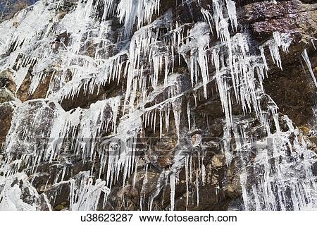 Stock Photo - Low angle view of frozen waterfall. Fotosearch
