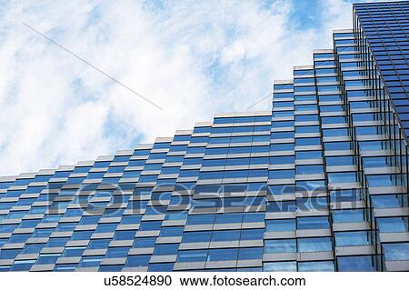 Low angle view of modern skyscraper against blue sky View Large Photo Image Stock Image - Low angle view of modern skyscraper against blue sky. Fotosearch