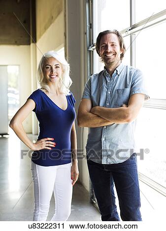 Man and woman standing by window View Large Photo Image Stock Image - Man and woman standing by window. Fotosearch