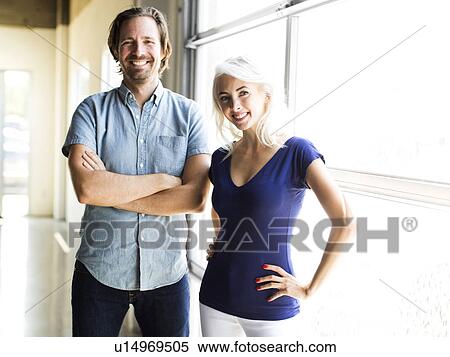 Man and woman standing by window View Large Photo Image Stock Photography - Man and woman standing by window. Fotosearch