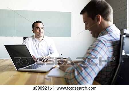Man being interviewed in conference room View Large Photo Image Stock Image - Man being interviewed in conference room. Fotosearch