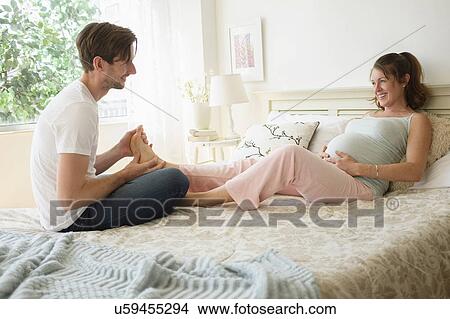 Man massaging pregnant woman's feet View Large Photo Image Picture - Man massaging pregnant woman's feet. Fotosearch