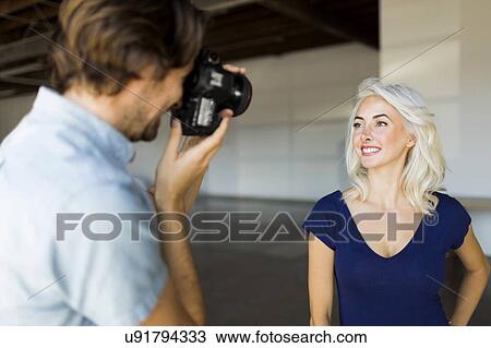 Man photographing woman View Large Photo Image Stock Image - Man photographing woman. Fotosearch