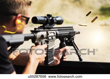 Man shooting rife View Large Photo Image Stock Photograph - Man shooting rife. Fotosearch