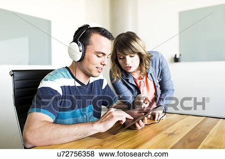 Man showing woman his music on smart phone View Large Photo Image Stock Photo - Man showing woman his music on smart phone. Fotosearch