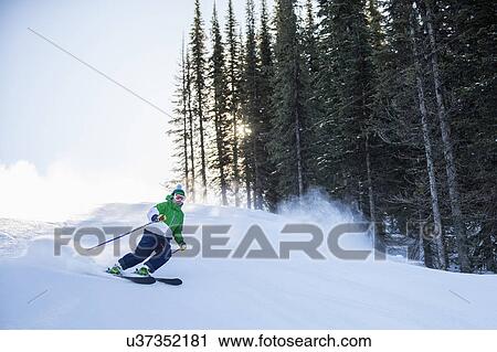 Stock Image - Man skiing downhill. Fotosearch