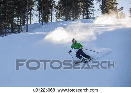 Man skiing downhill View Large Photo Image Stock Photo - Man skiing downhill. Fotosearch