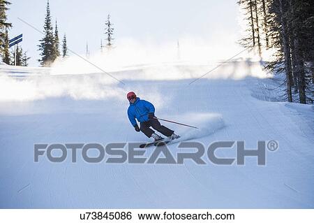 Stock Photograph - Man skiing downhill. Fotosearch