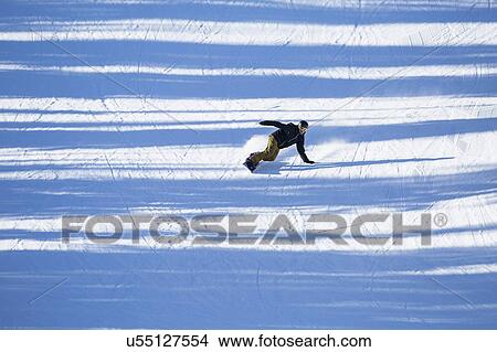 Man snowboarding downhill View Large Photo Image Picture - Man snowboarding downhill. Fotosearch