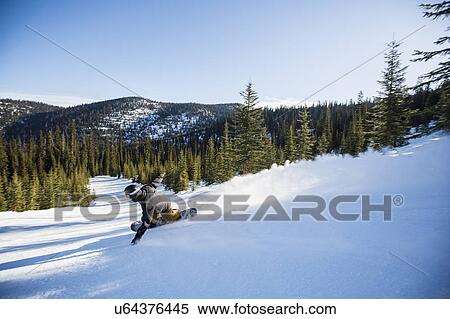 Man snowboarding downhill View Large Photo Image Stock Photography - Man snowboarding downhill. Fotosearch