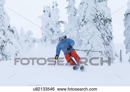 Stock Photograph - Mature man speeding on ski slope. Fotosearch