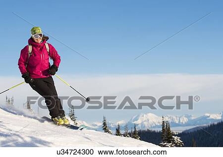 Mature woman on ski slope against sky View Large Photo Image Stock Image - Mature woman on ski slope against sky. Fotosearch