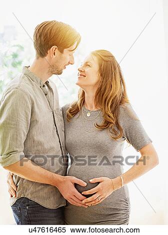 Stock Photography - Mid-adult couple face to face outdoors. Fotosearch