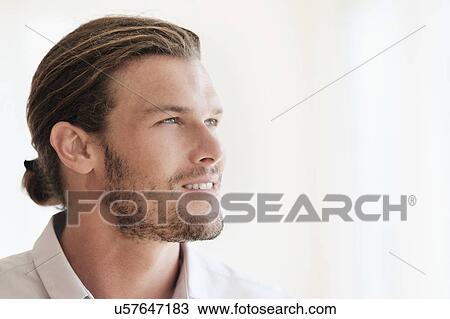 Stock Image - Mid-adult man looking away. Fotosearch