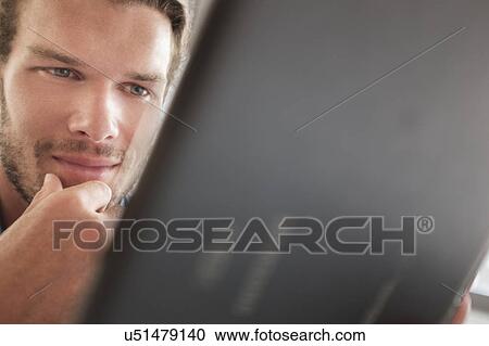 Mid-adult man using tablet pc View Large Photo Image Stock Image - Mid-adult man using tablet pc. Fotosearch