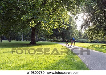 Mother and son (12-13) exercising in park View Large Photo Image Stock Image - Mother and son (12-13) exercising in park. Fotosearch