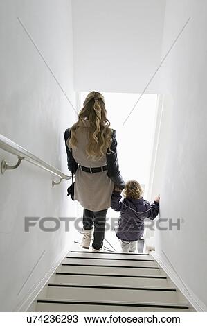 Mother and son (4-5) walking down stairs View Large Photo Image Stock Image - Mother and son (4-5) walking down stairs. Fotosearch