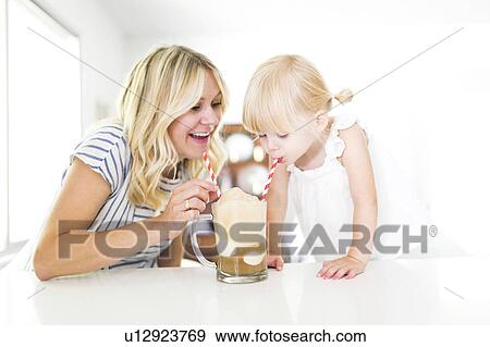 Mother drinking milkshake with daughter (2-3) View Large Photo Image Stock Photo - Mother drinking milkshake with daughter (2-3). Fotosearch