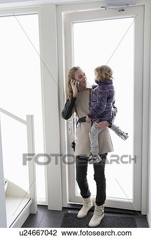 Stock Image - Mother holding son (4-5). Fotosearch