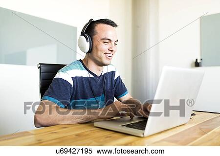 Stock Photography - Office worker using laptop. Fotosearch