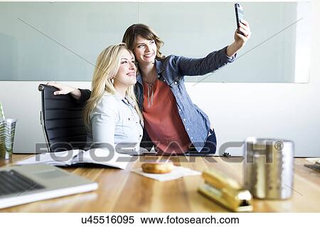 Office workers taking selfie View Large Photo Image Stock Photography - Office workers taking selfie. Fotosearch