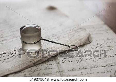 Stock Photo - Old magnifying glass and letters. Fotosearch