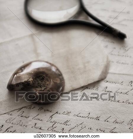Stock Photography - Old magnifying glass, shell and letters. Fotosearch