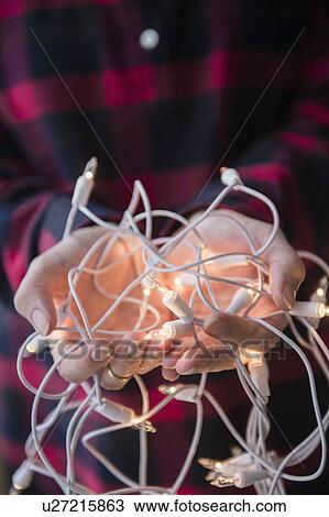 Person holding Christmas lights View Large Photo Image Stock Image - Person holding Christmas lights. Fotosearch