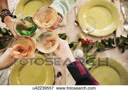 Personal perspective of people with martini glasses at festive table View Large Photo Image Stock Photo - Personal perspective of people with martini glasses at festive table. Fotosearch