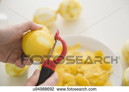 Stock Image - Personal point of view of person peeling lemons. Fotosearch