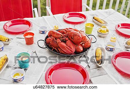 Stock Photography - Plate with lobsters on dining table. Fotosearch