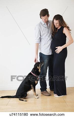 Stock Image - Portrait of couple with dog. Fotosearch