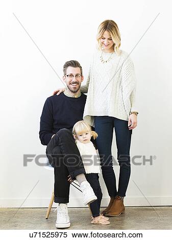 Stock Photography - Portrait of cute girl (2-3) with parents. Fotosearch