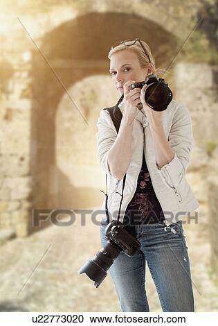 Stock Image - Portrait of female photographer. Fotosearch