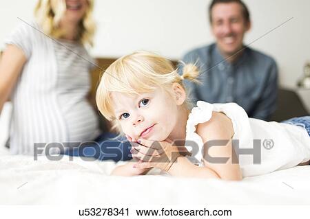 Stock Image - Portrait of girl (2-3) and parents. Fotosearch