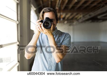 Portrait of man with digital camera View Large Photo Image Picture - Portrait of man with digital camera. Fotosearch