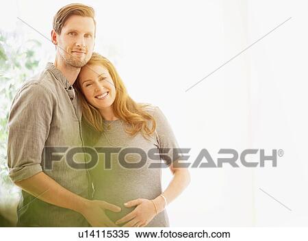 Stock Photography - Portrait of mid-adult couple outdoors. Fotosearch