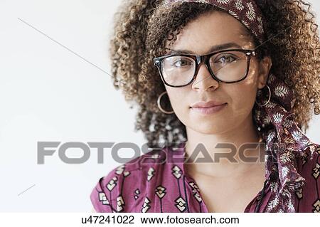 Stock Image - Portrait of smiling woman with curly hair. Fotosearch